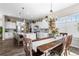 Well-lit eat-in kitchen featuring a large island, stylish wooden table, and stainless steel appliances at 853 Stagecoach Dr, Lafayette, CO 80026