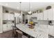 A sprawling kitchen featuring updated appliances, a kitchen island, and granite countertops at 853 Stagecoach Dr, Lafayette, CO 80026