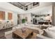 Bright open-concept living room with soaring ceilings, second-floor overlook, and adjacent kitchen with island at 853 Stagecoach Dr, Lafayette, CO 80026