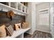 Welcoming mudroom with a wooden accent wall, bench seating, and storage cubbies at 853 Stagecoach Dr, Lafayette, CO 80026