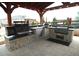 Gourmet outdoor kitchen featuring a built-in grill, pizza oven, and ample countertop space at 853 Stagecoach Dr, Lafayette, CO 80026