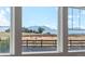 Window view featuring the mountains, a fence and an adjacent home and golden grasses at 853 Stagecoach Dr, Lafayette, CO 80026
