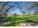 Autumn Ash Park features a green lawn, walking path, and trees, providing a serene environment for outdoor recreation at 803 W Lucerne Dr, Lafayette, CO 80026