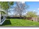 A spacious backyard with a well-maintained lawn, a covered patio, and a wooden fence, perfect for outdoor activities and privacy at 803 W Lucerne Dr, Lafayette, CO 80026