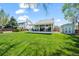 Well-manicured backyard with a spacious lawn, covered patio with seating, and a shed for storage at 803 W Lucerne Dr, Lafayette, CO 80026