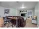 Finished basement rec room with ample seating, a table, and a mounted TV, creating an ideal entertainment space at 803 W Lucerne Dr, Lafayette, CO 80026