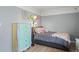 Cozy bedroom with unique colorful accents, gray walls, wood flooring, and ample natural light at 803 W Lucerne Dr, Lafayette, CO 80026