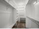 Walk-in closet featuring custom shelving, laminate flooring, and plenty of storage space at 803 W Lucerne Dr, Lafayette, CO 80026