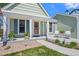 Quaint front porch featuring a decorative door, white columns, and vibrant flower pots adding charm and curb appeal at 803 W Lucerne Dr, Lafayette, CO 80026