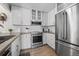Modern kitchen featuring stainless steel appliances, quartz countertops, and ample cabinet space at 803 W Lucerne Dr, Lafayette, CO 80026