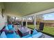Relaxing covered patio with comfortable seating, a fire table, and views of the well-kept backyard and the open space beyond at 803 W Lucerne Dr, Lafayette, CO 80026