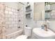 Modern bathroom with subway tile shower, stylish vanity, and decorative shelving at 5033 Goshawk Ct, Brighton, CO 80601