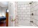 Tiled bath/shower combination with view to Primary Bedroom at 5033 Goshawk Ct, Brighton, CO 80601