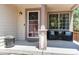 Inviting front porch with seating, a decorative wreath, and a potted plant, creating a welcoming entrance at 5033 Goshawk Ct, Brighton, CO 80601