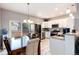 Bright kitchen featuring stainless steel appliances, granite countertops, and an open layout to the dining area at 5033 Goshawk Ct, Brighton, CO 80601