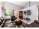 Spacious living room with leather furniture, large windows, and a TV, offering a comfortable and stylish space at 5033 Goshawk Ct, Brighton, CO 80601