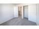 Bedroom with carpet, double door closet and access to hallway at 1090 Quail Cir, Brighton, CO 80601