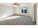 Spacious bedroom with carpet, ceiling fan, and window at 1090 Quail Cir, Brighton, CO 80601