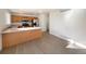 Kitchen with wood cabinets, island and stainless steel appliances at 1090 Quail Cir, Brighton, CO 80601