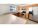 Kitchen with wood cabinets, stainless steel appliances, and a large island at 1090 Quail Cir, Brighton, CO 80601