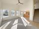 Open living room with hardwood floors, carpet, and kitchen view at 1090 Quail Cir, Brighton, CO 80601