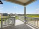 Back deck with white railing offering scenic views of the surrounding landscape at 17424 E 90Th Pl, Commerce City, CO 80022