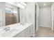 Bathroom featuring double sink vanity, large mirror, and a glass enclosed shower at 17424 E 90Th Pl, Commerce City, CO 80022