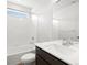 Bright bathroom with white tile tub, dark vanity with white countertop and modern faucet at 17424 E 90Th Pl, Commerce City, CO 80022