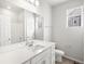 Modern bathroom features double vanity, large mirror, and sleek fixtures, complemented by a shower and separate toilet area at 17424 E 90Th Pl, Commerce City, CO 80022