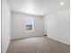 Empty bedroom with plush carpet, neutral wall color and window view at 17424 E 90Th Pl, Commerce City, CO 80022