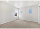 Bright, carpeted bedroom featuring three windows providing ample natural light and a neutral color palette at 17424 E 90Th Pl, Commerce City, CO 80022
