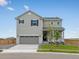 Charming two-story home with a well-manicured lawn and an attached two-car garage at 17424 E 90Th Pl, Commerce City, CO 80022