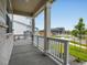 Inviting covered porch with white columns, overlooking a landscaped front yard and quiet street at 17424 E 90Th Pl, Commerce City, CO 80022