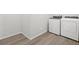 Well-equipped laundry area with modern washer and dryer on wood-look flooring for convenience and style at 17424 E 90Th Pl, Commerce City, CO 80022