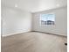 Bright living room features wood-look floors and a large window for natural light at 17424 E 90Th Pl, Commerce City, CO 80022