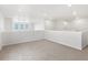 Spacious loft area with neutral carpet, white walls, and natural light from multiple windows at 17424 E 90Th Pl, Commerce City, CO 80022