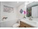 Modern bathroom featuring unique window design, and a vanity with a wooden cabinet at 2767 W 38Th Ave, Denver, CO 80211