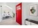 Inviting entryway with a bright red door, skylight, and modern decor, leading into a cozy living space at 2767 W 38Th Ave, Denver, CO 80211