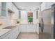 Updated kitchen features white cabinets, stainless steel appliances, and under-cabinet lighting at 2767 W 38Th Ave, Denver, CO 80211