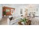 Bright living room with exposed brick wall, white sofa, and open floor plan to the dining area at 2767 W 38Th Ave, Denver, CO 80211
