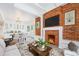 Inviting living room with exposed brick, cozy fireplace, and open to the dining area at 2767 W 38Th Ave, Denver, CO 80211