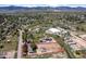 Aerial view of the outlined property; horse arena, multiple outbuildings, house and surroundings at 16225 W 74Th Dr, Arvada, CO 80007