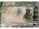 Aerial view showcasing the property, horse arena, outbuildings, and a glimpse of the residence at 16225 W 74Th Dr, Arvada, CO 80007