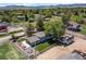 Aerial view featuring a spacious backyard with a patio, fire pit, and horse property at 16225 W 74Th Dr, Arvada, CO 80007