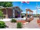 This charming backyard offers a cozy patio, pergola, seating, and beautiful landscaping at 16225 W 74Th Dr, Arvada, CO 80007
