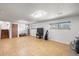 Finished basement space with tile floors, bright lighting, and windows at 16225 W 74Th Dr, Arvada, CO 80007