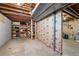 Unfinished basement with shelving and exposed beams at 16225 W 74Th Dr, Arvada, CO 80007
