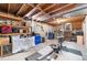 Unfinished basement with exposed wood beams and shelving at 16225 W 74Th Dr, Arvada, CO 80007