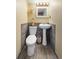Half bathroom with pedestal sink, tile accent wall, and charming decor at 16225 W 74Th Dr, Arvada, CO 80007