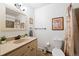 Bright bathroom featuring a vanity with mirror, toilet, and shower with decorative curtain at 16225 W 74Th Dr, Arvada, CO 80007
